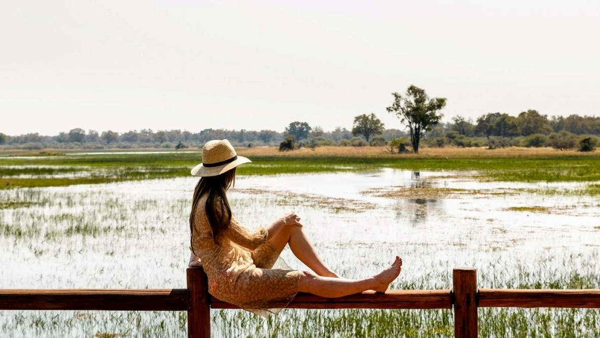 Okavango-Delta-view-from-camp Woman content in solitude observing the beauty of the Delta
