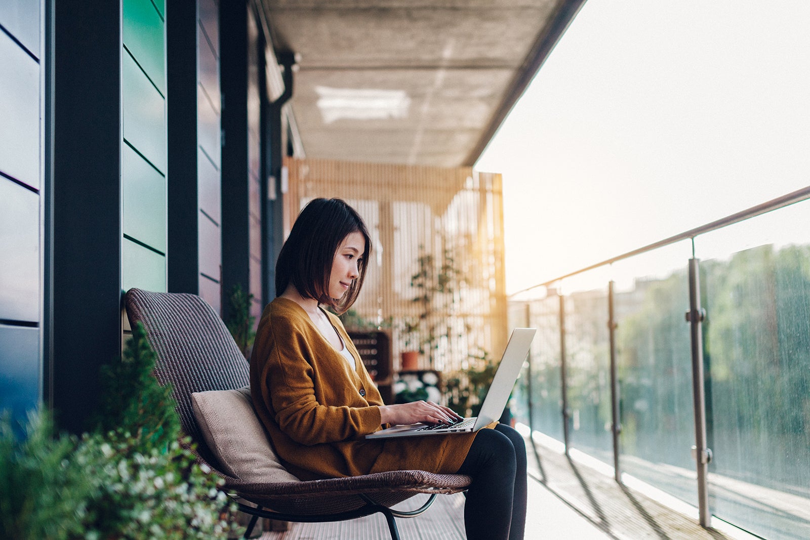 Woman using her laptop outdoors